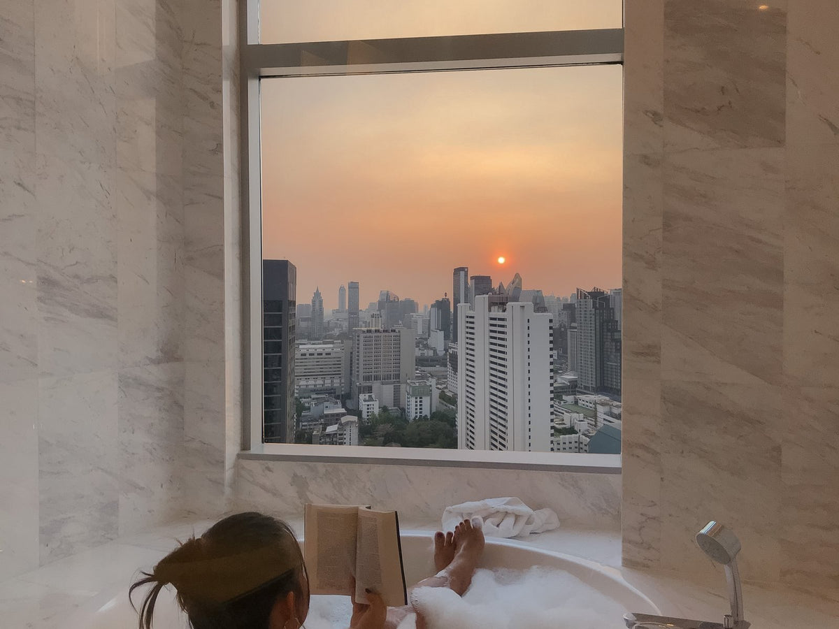 Woman resting and reading at sunset