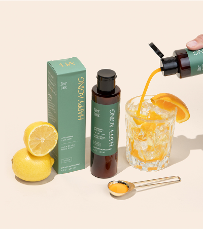 Liver tonic bottle with lemons and a citrus drink