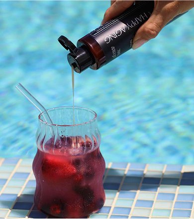 Tonic being poured into a berry drink by the pool